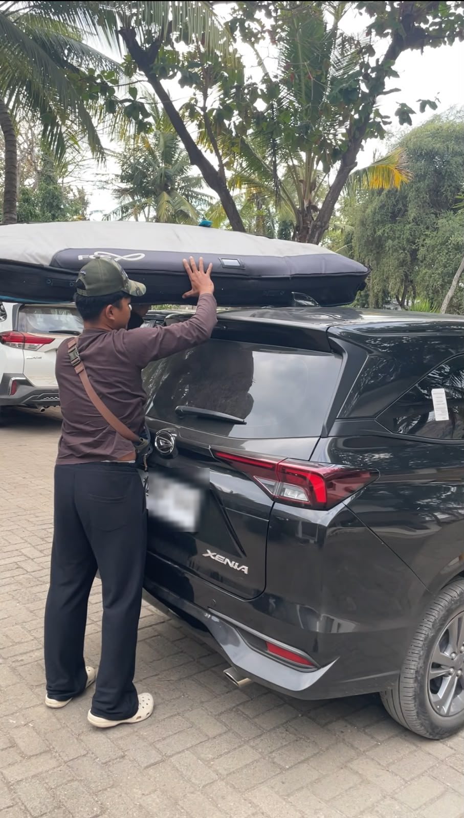 Surfboard secured on a private Sumbawa Transfer vehicle