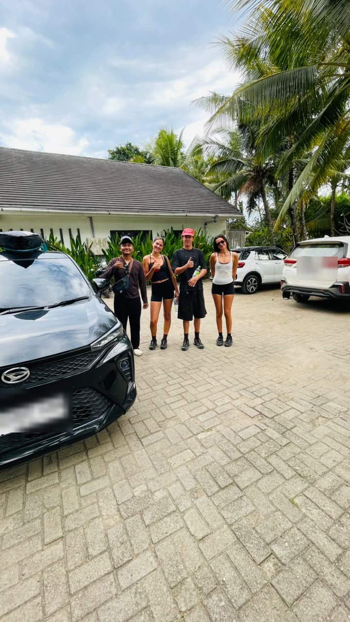Travelers with a local Sumbawa Transfer driver and private vehicle